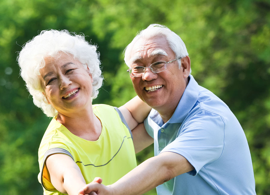 Elderly couple dancing together outdoors Elderly couple dancing together outdoors